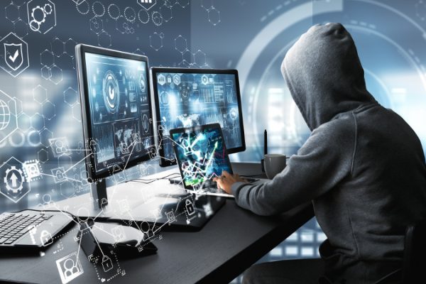 Side view of hacker using computer with digital interface while sitting at desk of blurry interior. Hacking and information concept. 3D Rendering